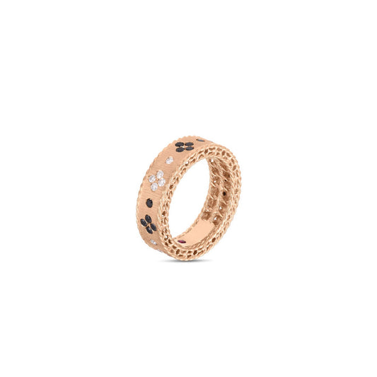 The Roberto Coin Venetian Princess 18K Rosé Gold with Black and White Diamond Ring showcases a textured rose gold surface embellished with intricate black and white floral motifs encircling the band.