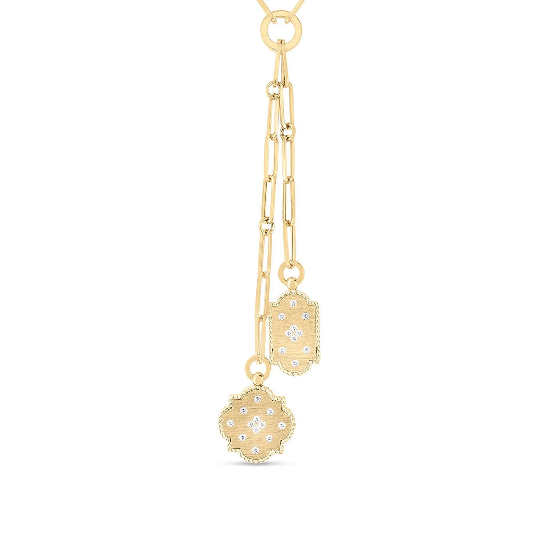 The Roberto Coin Venetian Princess 18K yellow gold double medallion necklace features geometric pendants with diamond accents, suspended from elongated chain links for a modern, elegant look.