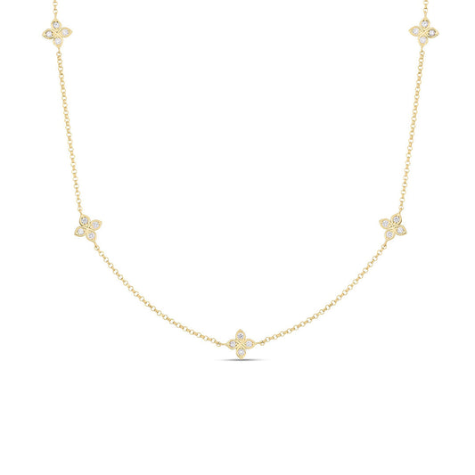 The Roberto Coin Love by the Inch 18K Yellow Gold Diamond 5 Station Flower Necklace showcases five floral diamond clusters (0.22 TCW) along an adjustable fine chain, displayed on a white background.