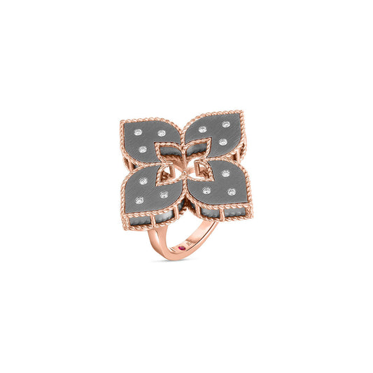 Discover the Roberto Coin Venetian Princess 18K Rose Gold Flower Ring, adorned with large grey titanium petals and sparkling diamond accents. This exquisite piece embodies the brand's renowned craftsmanship, showcasing intricate details on a sophisticated rose gold band.