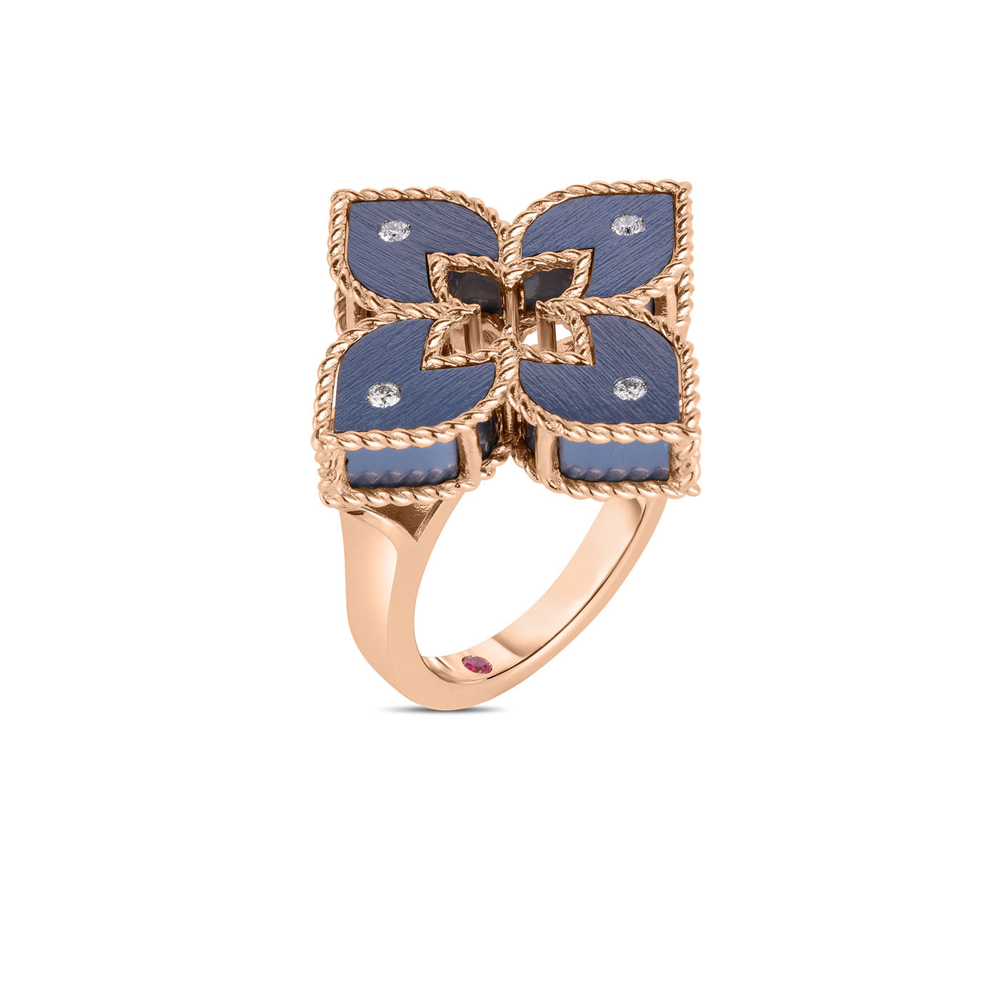 The Roberto Coin Venetian Princess 18K Rose Gold Small Blue Titanium and Diamond Flower Ring captures elegance with its intricate flower-shaped design, featuring blue titanium petals and small diamond accents. The smooth finished band perfectly complements the ornate top design.