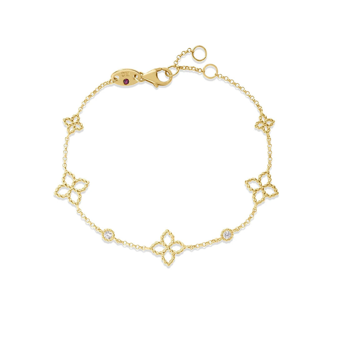 The Roberto Coin Princess Flower 18K Yellow Gold Diamond Station Bracelet features five floral-shaped charms with diamond accents, fine detailing, and an adjustable clasp—signature elegance from Roberto Coin.