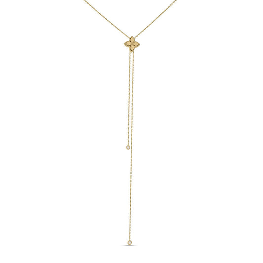 The Roberto Coin Princess Flower 18K Yellow Gold Diamond Accent Lariat Necklace features a delicate clover pendant and two fine chains of varying lengths, each ending in a small round detail, for a minimal and elegant look.