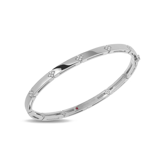 The Roberto Coin Love In Verona 18K White Gold Diamond Accent Bangle features sleek white gold with evenly spaced floral motifs adorned with sparkling diamonds.