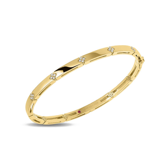 The Roberto Coin Love In Verona 18K Yellow Gold Diamond Accent Bangle features evenly spaced diamond accents and a smooth, elegant design inspired by the romance of Verona.