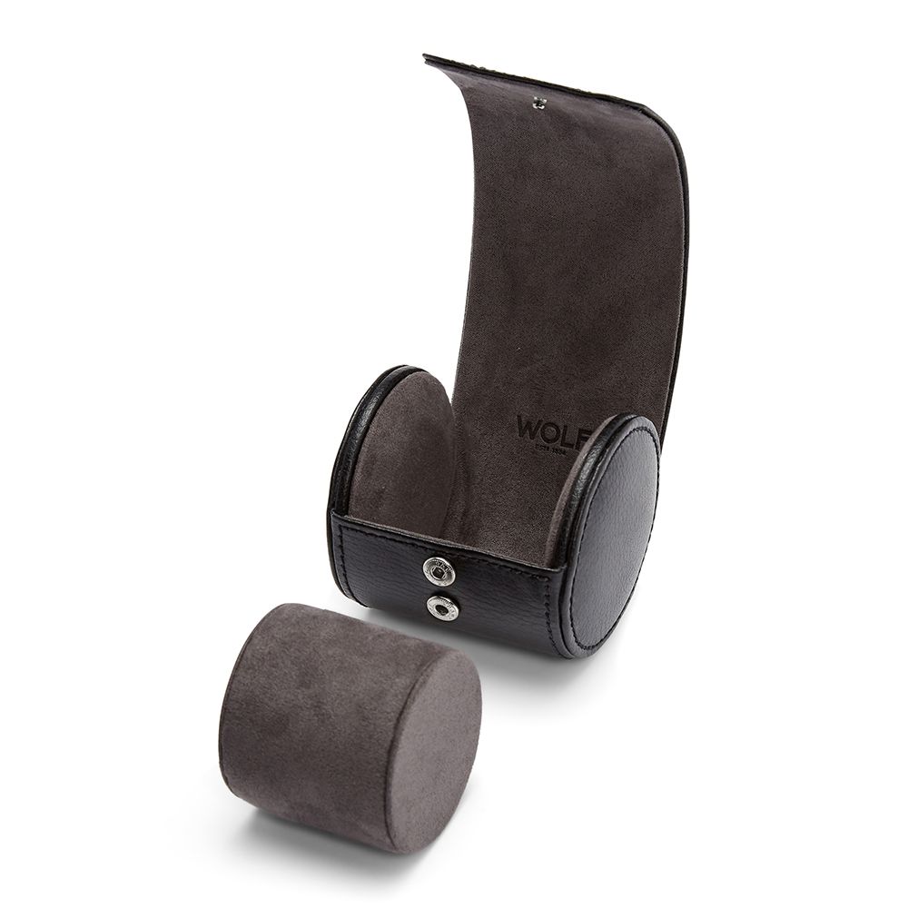 The WOLF 1834 British Racing Single Watch Roll is a black and grey leather cylinder with a suede interior, compact design, open lid, matching round cushion displayed outside, and "WOLF" branding inside.