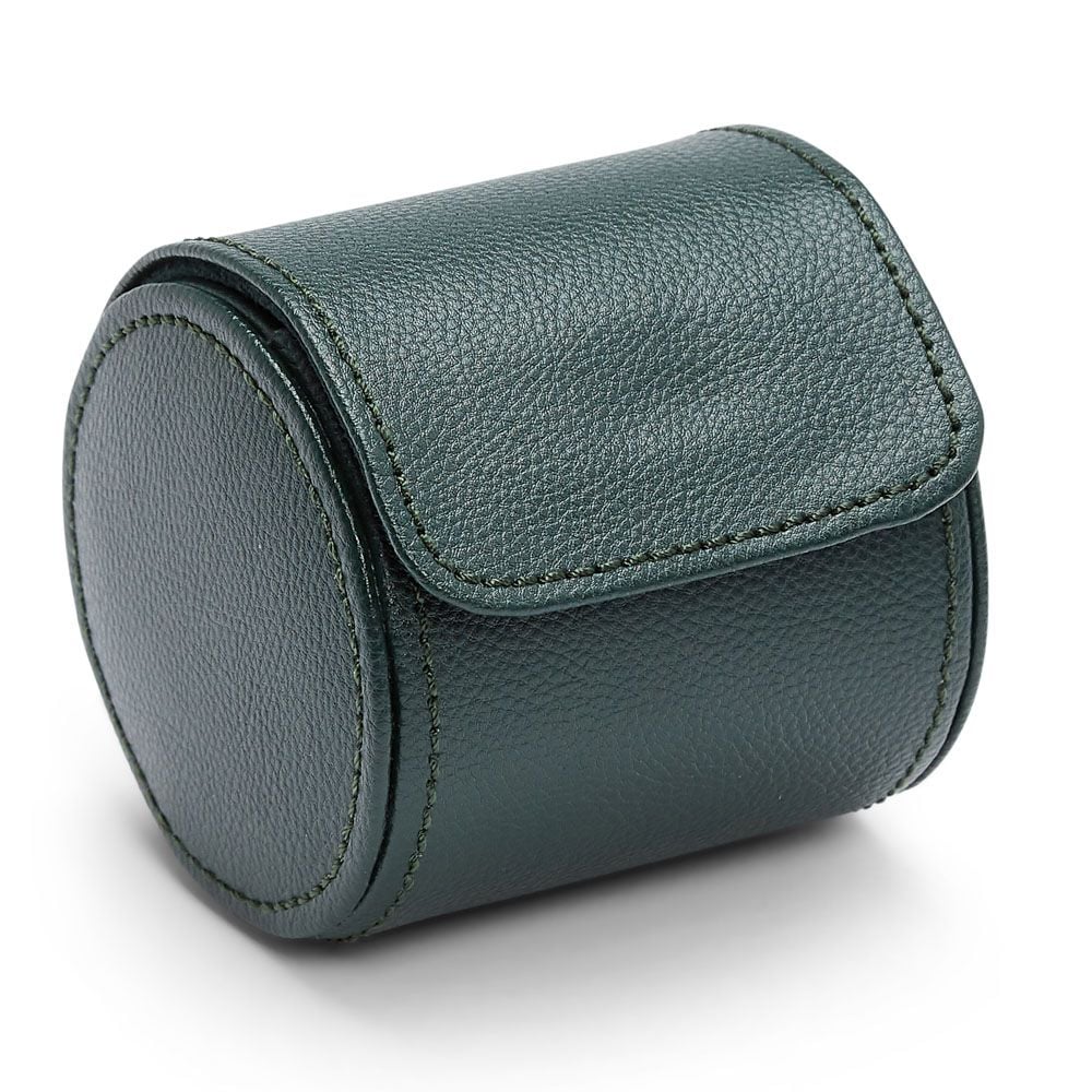 The WOLF 1834 British Racing Single Watch Roll by WOLF is a round, dark green vegan leather case with a flap closure, visible stitching, textured surface, and compact design—ideal for storing your watch roll. Shown on a white background.