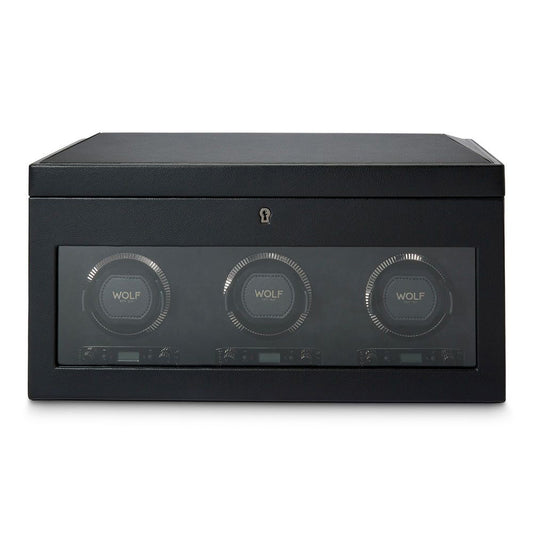 Introducing the WOLF 1834 British Racing Triple Watch Winder With Storage: a stylish black winder featuring three circular compartments within a sleek rectangular case. Each compartment proudly bears the "WOLF" insignia and includes a transparent front panel. This patented design offers multiple rotation options, ensuring your automatic watches are perfectly wound.