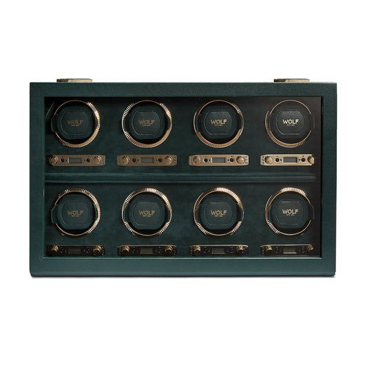 The WOLF 1834 British Racing 8PC Watch Winder is a luxurious green leather-framed device, designed with two rows of four circular holders. Each holder prominently displays the "WOLF" brand name behind a transparent cover and incorporates patented technology that provides various rotation options to maintain your timepieces in perfect condition.