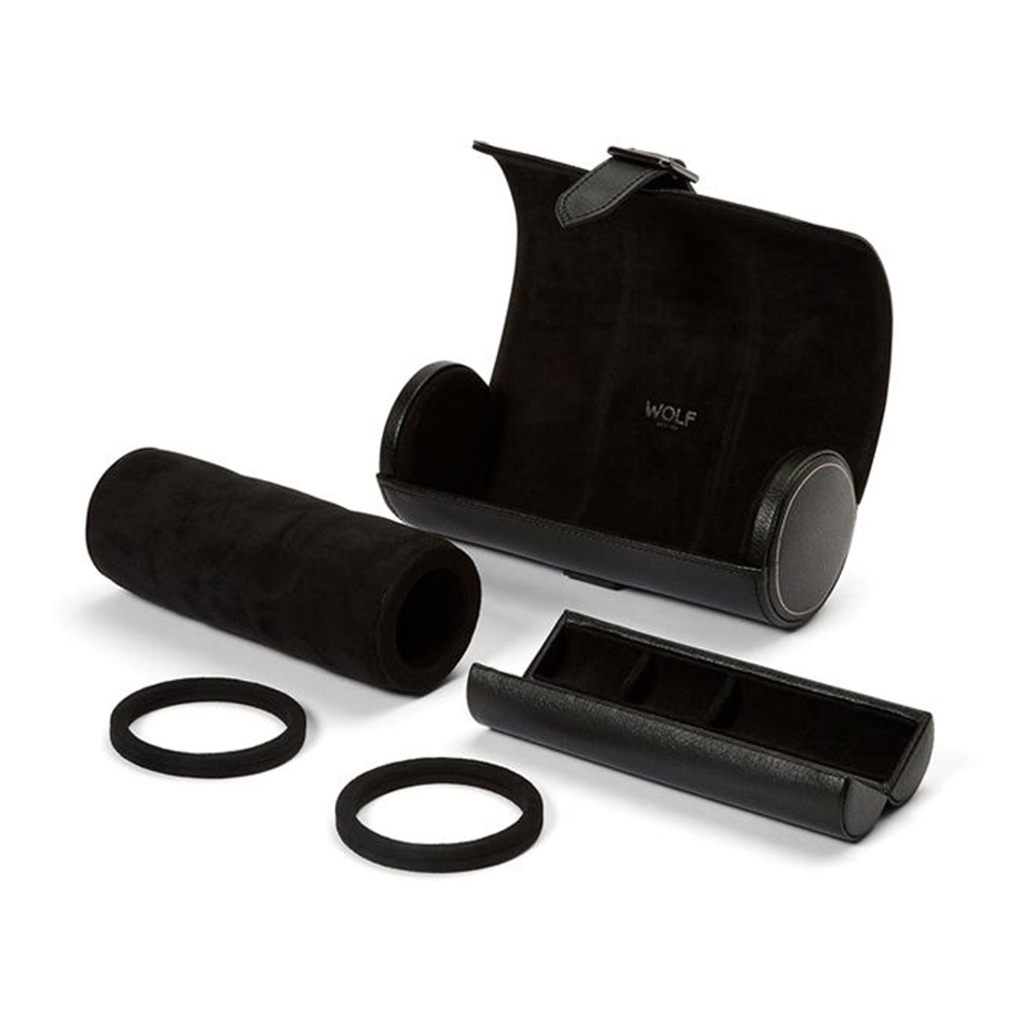 The WOLF 1834 British Racing Triple Watch Rolls, crafted by WOLF, is a sleek black cylindrical case featuring "WOLF" inscribed on the interior. It has a plush velvet-like lining, two circular end caps, and an internal cushion designed to securely hold your watches. This stylish jewelry capsule is ideal for organizing and safeguarding your treasured timepieces while traveling.