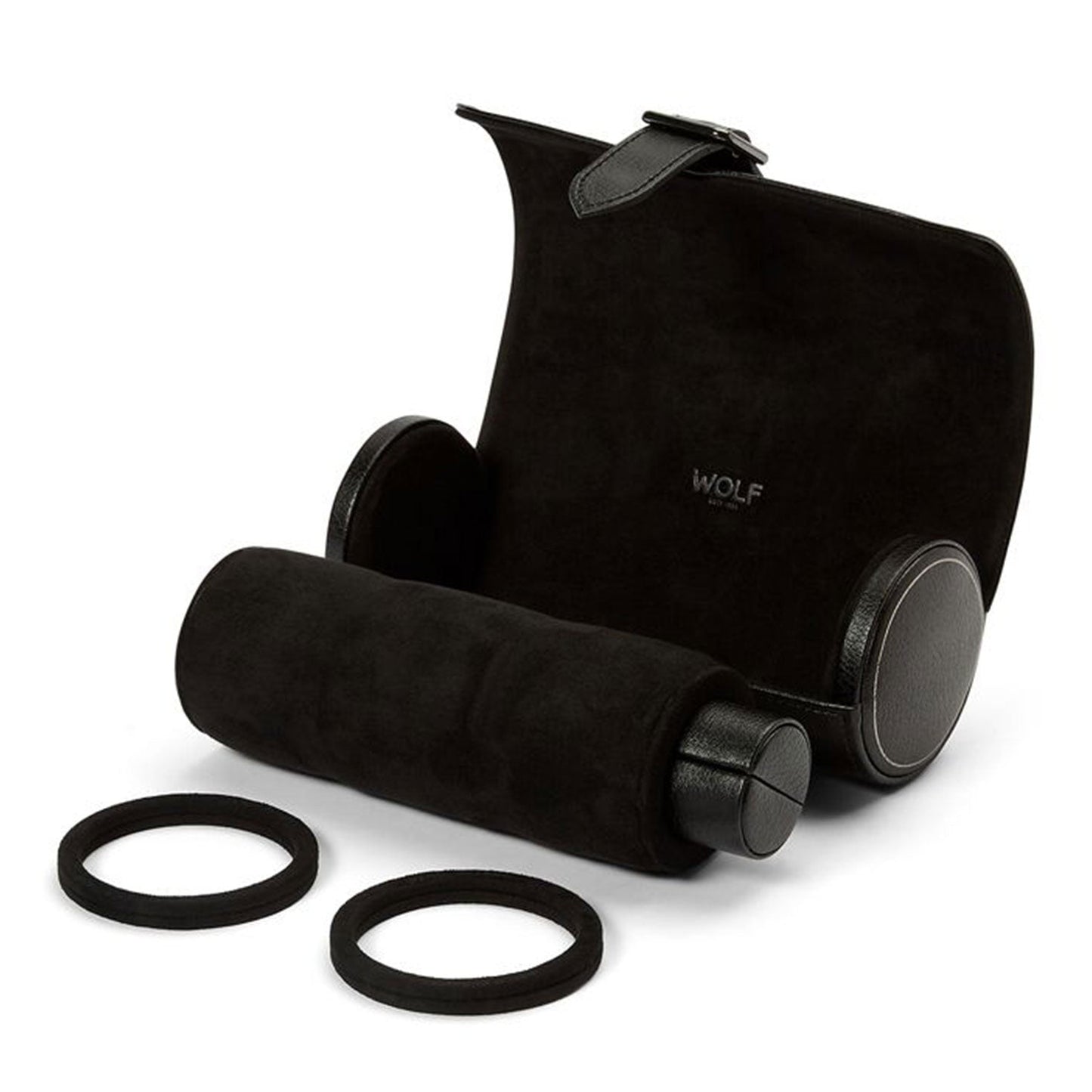 Partially open to display its cylindrical form, the WOLF 1834 British Racing Triple Watch Roll features a black leather exterior and a soft suede interior. Beside it are two removable watch guards and elastic bands. The brand name "WOLF" is elegantly embossed on the interior, highlighting its stylish design for securely storing timepieces.