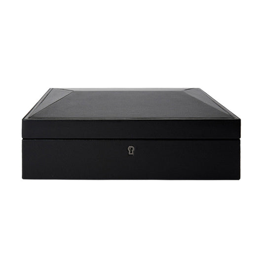 The WOLF 1834 British Racing 15 Piece Watch Box by WOLF is a sophisticated black rectangular case, crafted from vegan leather with a smooth surface and subtle detailing on the edges. It features a keyhole on the front for lock and key security, making it ideal for elegantly storing watches while perfectly balancing modern design with functionality.