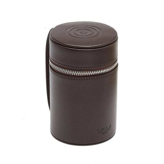 Introducing the WOLF 1834 WM Brown Negroni Astuccio Beverage: a sleek, brown cylindrical leather case crafted for the contemporary gentleman. It features a zipper around its top section, adorned with a circular pattern on the lid and "WOLF" embossed at the bottom. Designed to conveniently hold your essentials, it comes with a side strap that echoes the style of a traditional Negroni Beverage Astuccio.