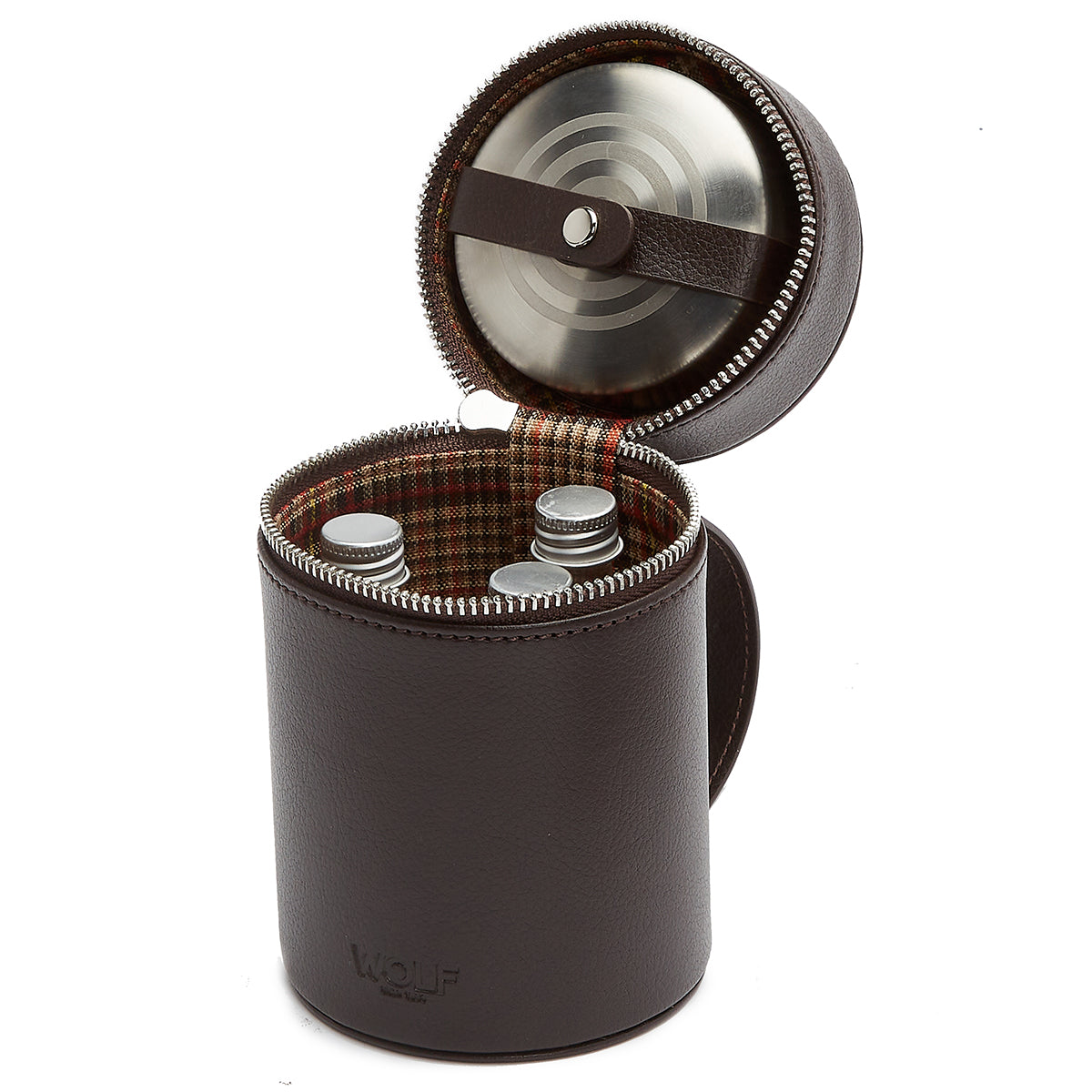 The WOLF 1834 WM Brown Negroni Astuccio Beverage by WOLF is a cylindrical leather carrying case with a plaid interior. It opens at the top to reveal three silver-colored metal containers, ideal for your Negroni beverage essentials. The lid includes a circular compartment and secures with a zip closure.