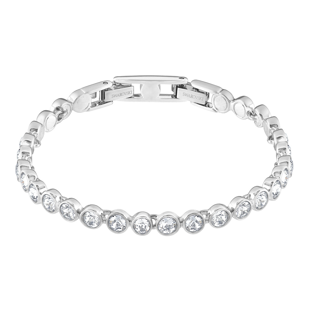The Swarovski Tennis Bracelet by Swarovski is elegantly embellished with round cut crystals, perfectly spaced along its rhodium-plated band and features a clasp at the top.