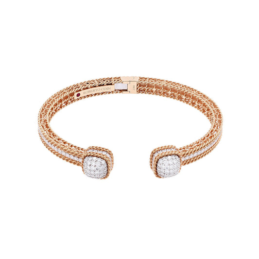 The Roberto Coin 18K Rose Gold Roman Barocco Diamond Dome End Bangle is a luxurious piece featuring intricate woven detailing, diamond-encrusted dome ends, and a subtle engraved logo plate. Its open, flexible design epitomizes the elegant Roman Barocco style.