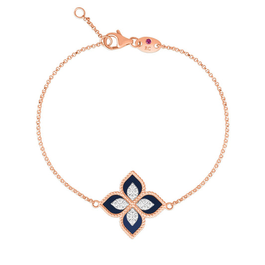 The Roberto Coin Princess Flower 18K Rosé Gold Lapis and Diamond Bracelet features a floral-shaped pendant with navy lapis petals, accented by sparkling round diamonds. The refined pendant elegantly hangs from a delicate chain, ensuring secure closure with a gold clasp.