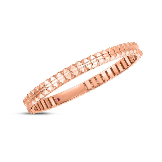 The Roberto Coin Obelisco 18K Rose Gold Hinged Bangle boasts a geometric, faceted design with a small purple gemstone accent, capturing the elegance and flair synonymous with Roberto Coin.