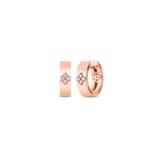 Two Roberto Coin Love In Verona 18K rose gold earrings with round diamond accents arranged elegantly. The earrings feature a floral design with a cluster of small diamonds set in the center, adding a touch of sparkle and sophistication. The background is plain white.