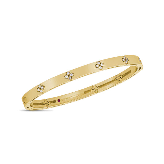 The Roberto Coin Love In Verona 18K Yellow Gold Diamond Bangle showcases clusters of diamond flowers evenly positioned around the band, offering a modern and sophisticated appearance.