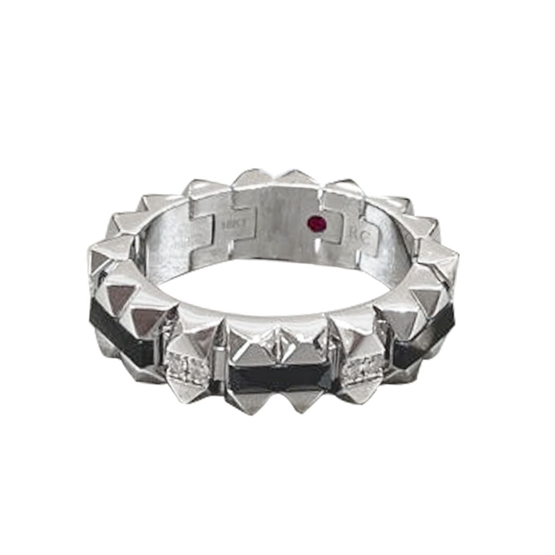 The Roberto Coin Obelisco 18K White Gold Black Jade and Diamond Ring features a geometric, pyramid-like pattern encircling the band, while a small red dot on the interior adds an intriguing touch.