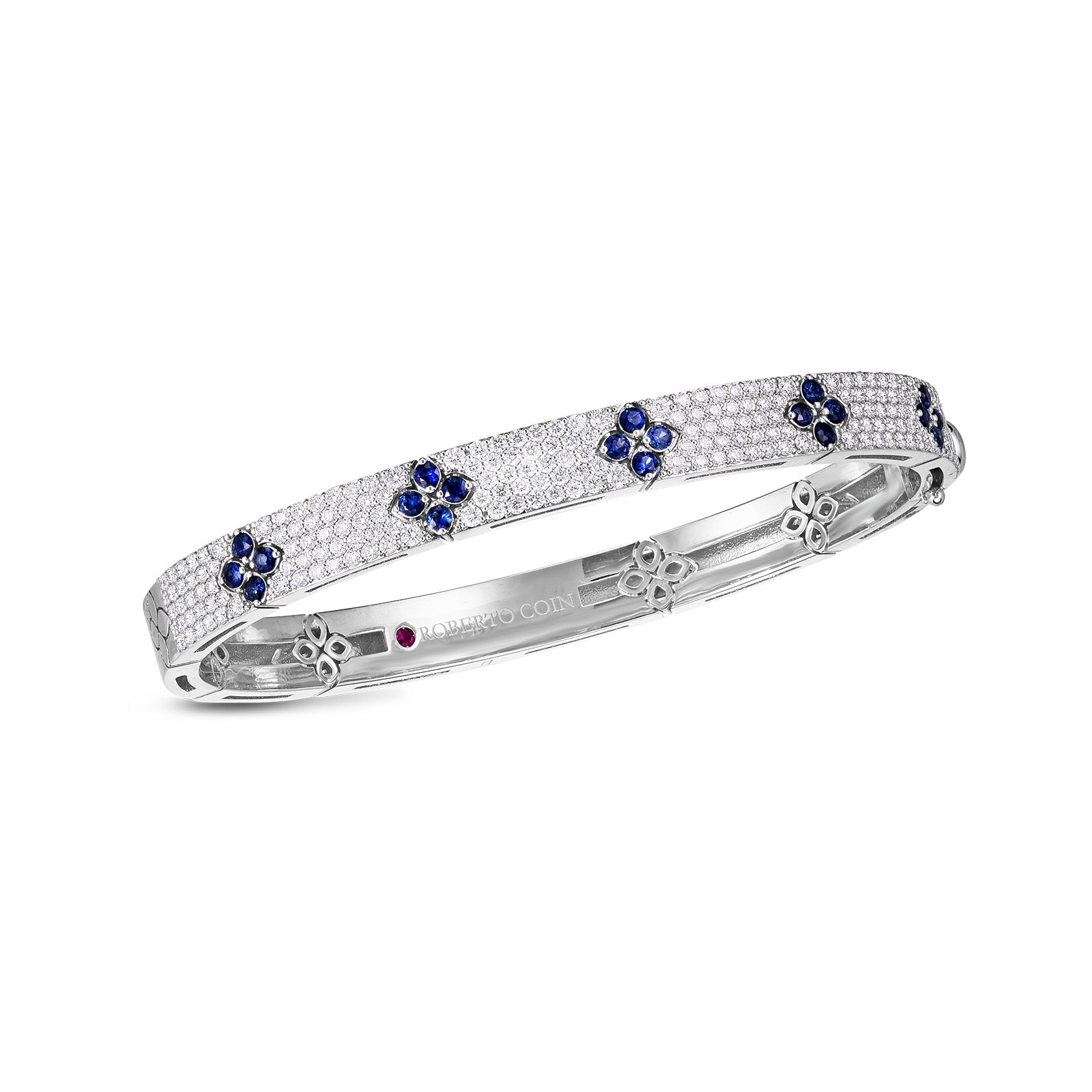 The Roberto Coin Love In Verona 18K White Gold Diamond Bangle showcases a series of small blue flower motifs adorned with blue sapphires and tiny crystals. Crafted by the brand Roberto Coin, this bracelet highlights finely detailed craftsmanship and a polished finish.