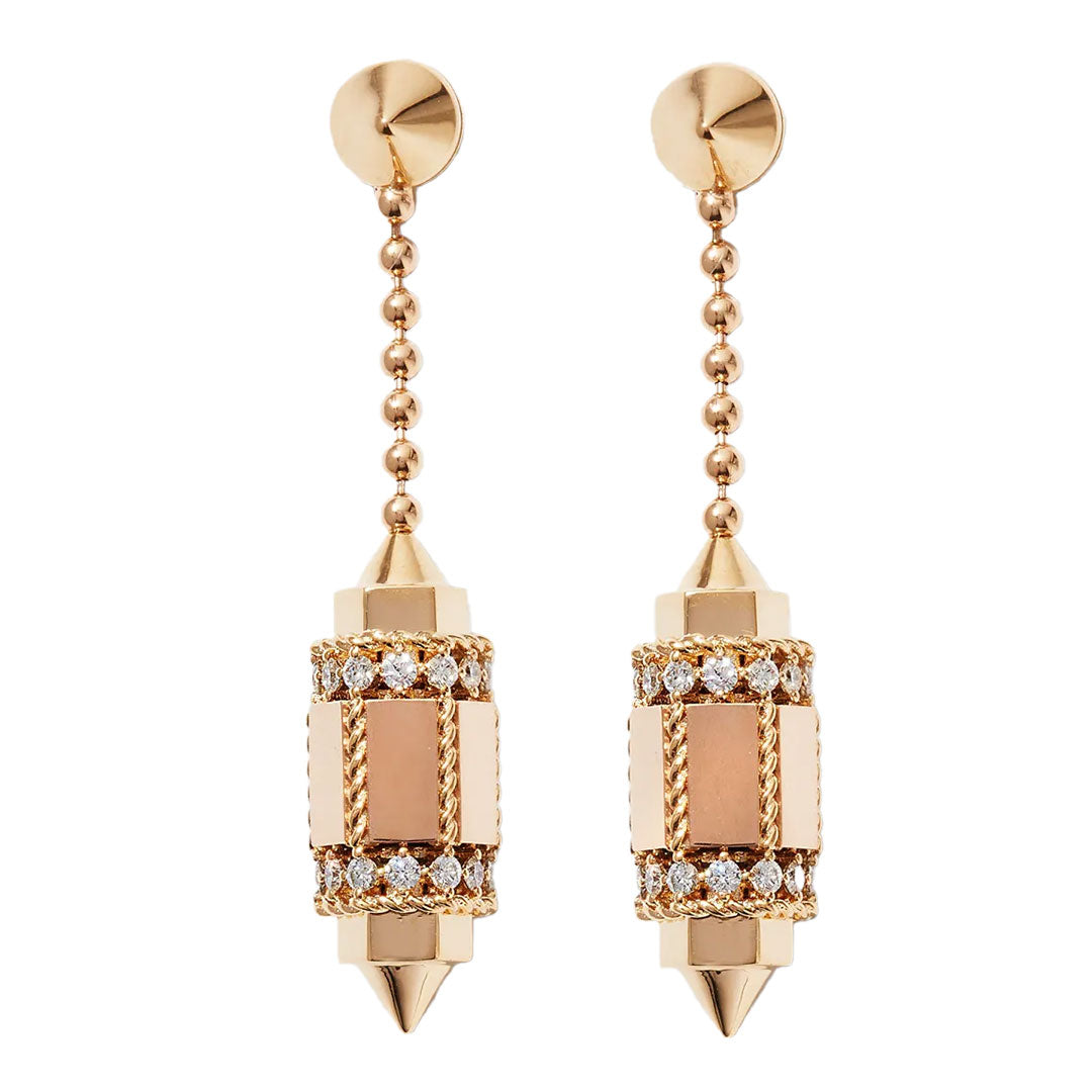 Roberto Coin's Art Deco-inspired diamond drop earrings in 18K yellow gold feature cylindrical pendants adorned with intricate details and dazzling white stones, exuding timeless sophistication.