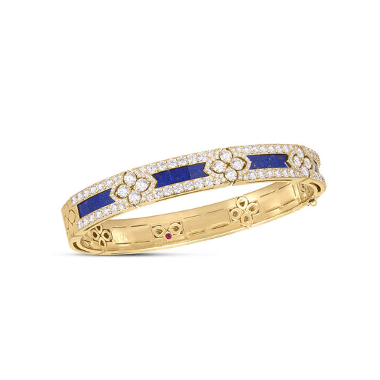 The Roberto Coin Love in Verona 18K Rose Gold and Lapis Bracelet showcases rectangular lapis gemstones surrounded by clusters of round, dazzling diamonds arranged in a symmetrical design. The band is beautifully embellished with floral motifs, adding an intricate touch of sophistication and elegance.