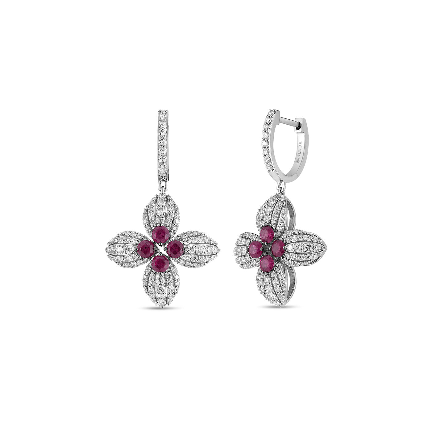 Introducing the Roberto Coin Love in Verona Earrings: Exquisitely crafted in 18K white gold, these earrings feature a floral design accented by radiant rubies at the center, encircled by sparkling clear diamonds. The petals mimic a blooming flower, offering an elegant touch to any ensemble.