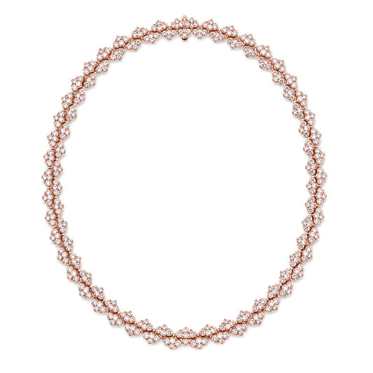 The Roberto Coin Cobra 18K Rose Gold Pave Diamond Collar Necklace features an intricate design, with clusters of sparkling white diamonds elegantly arranged around the rose gold chain to form a captivating circular silhouette reminiscent of a delicate diamond collar.