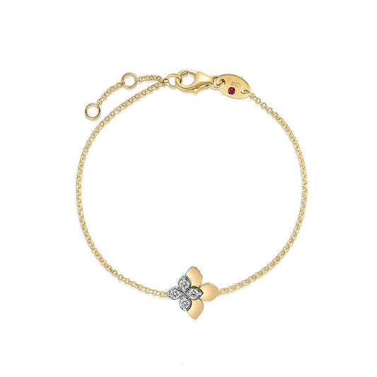 The Roberto Coin Love in Verona Stud 18K Yellow Gold Diamond Flower Bracelet features a fine gold chain, a diamond flower charm, an adjustable clasp with a small red gem, and draws inspiration from Roberto Coin’s signature style.