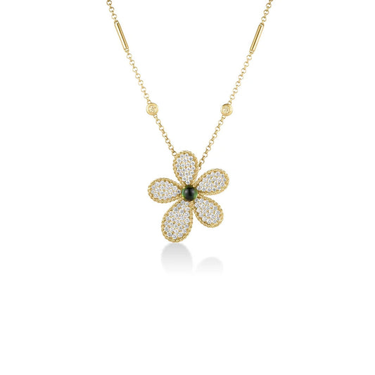 The Roberto Coin Jasmine 18K yellow gold necklace features a large daisy-shaped pendant adorned with five pavé diamond petals and a dark green tourmaline gemstone at its center. The chain is accented with small round diamonds on each side.