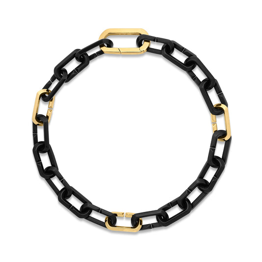 A Roberto Coin Designer Black Titanium and 18K Yellow Gold Chain Bracelet featuring alternating black and gold rectangular links, arranged in a circle on a white background.