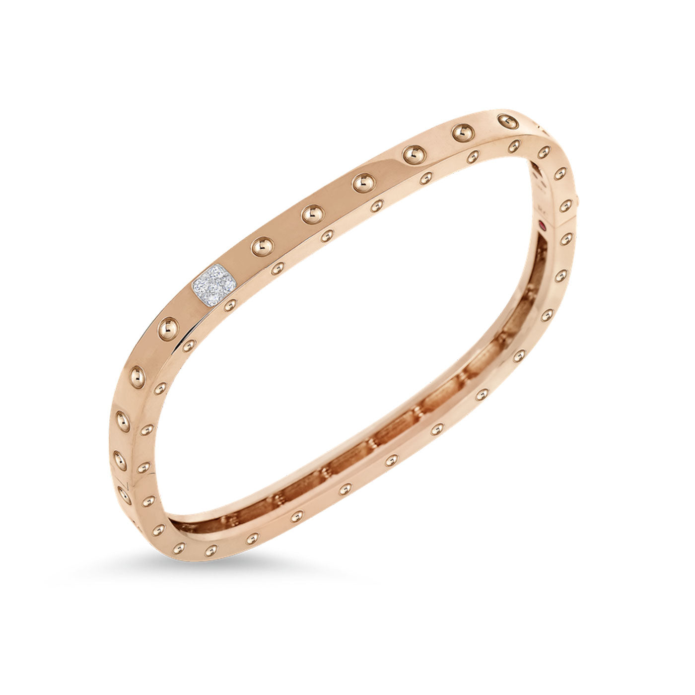 The Roberto Coin Pois Moi 18K Rose Gold Diamond Accent Square Bangle features a design adorned with evenly spaced rivet-like decorations and a section encrusted with sparkling diamonds. This bracelet from Roberto Coin embodies an elegant and contemporary design, seamlessly blending classic charm with modern sophistication.