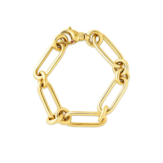 This bracelet from Roberto Coin showcases a sophisticated design, meticulously crafted with a harmonious arrangement of elongated oval and round links. The 18K Yellow Gold Oval And Round Link Bracelet features an 18-karat yellow gold clasp with an understated design that reflects light beautifully, enhancing its polished finish against a plain white background.