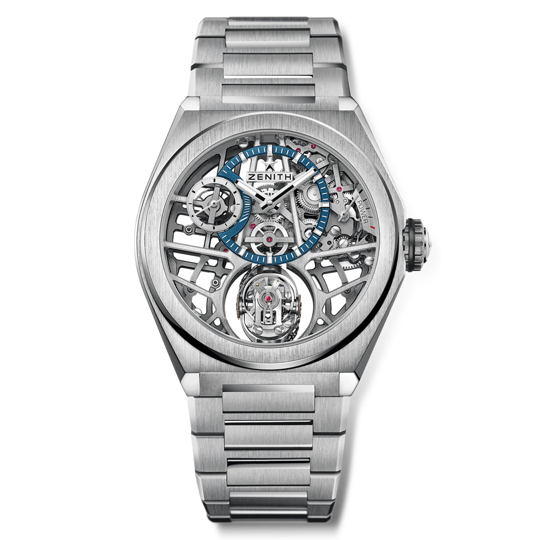 The ZENITH Defy Zero G El Primero 8812 S 44mm is a luxury watch with a titanium case and silver metal band, featuring gyroscopic skeleton mechanics with blue accents. It boasts Gravity Control, an open-work dial with visible gears, and the Zenith brand name on the face.