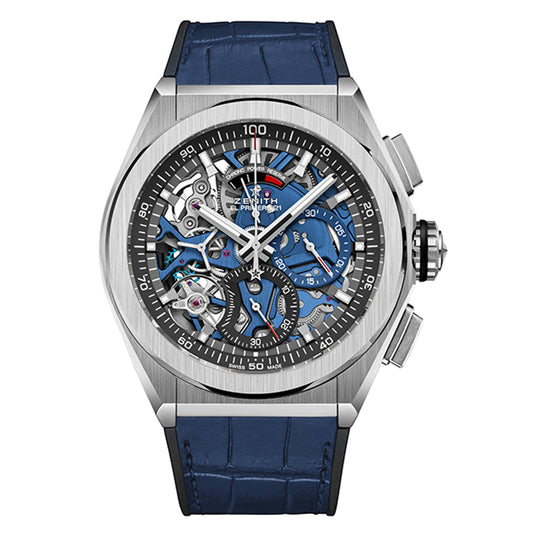 The Zenith Defy El Primero 21 44mm Watch is a luxury timepiece with a blue leather strap, silver case, and intricate skeleton dial that highlights its internal mechanics, adorned with blue and silver accents.