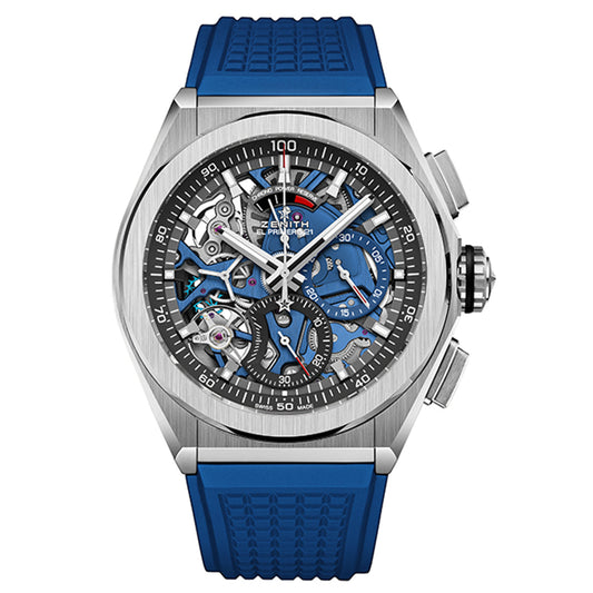 The ZENITH Defy El Primero 21 by Zenith is a luxury wristwatch with a blue strap and exposed gears. It features sub-dials, a tachymeter bezel, and combines silver, blue, and black in its skeletonized design.