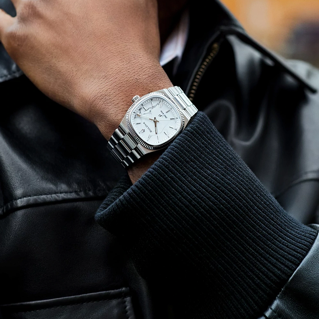 Bulova Super Seville Precisionist Quartz 35mm Watch in silver-tone with a white dial and a fluted bezel on a stainless steel bracelet, worn on a wrist.