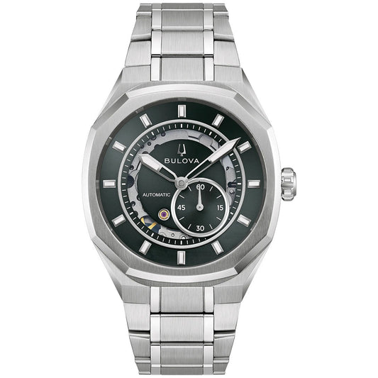 The Bulova Surveyor Marc Anthony Automatic 40.5mm Watch features a silver-tone stainless steel link band, a dark dial with geometric hour markers and subdials, and automatic movement; it’s shown from the front against a white background.