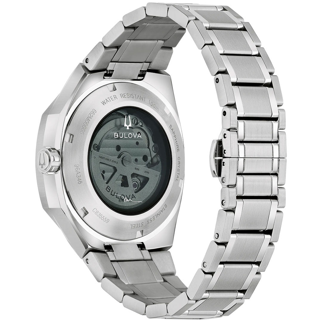 A Bulova Surveyor Marc Anthony Automatic 40.5mm men’s watch in silver with a metal link band, shown from the back. The transparent case reveals the inner automatic movement and engraved details on the watch back.