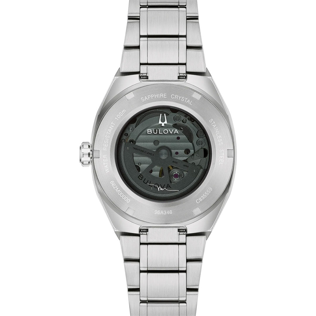 Back view of the Bulova Surveyor Marc Anthony Automatic 40.5mm Watch in stainless steel, featuring a transparent case back that displays its intricate automatic movement and engraved details about water resistance and materials—a sophisticated men’s timepiece inspired by Marc Anthony’s signature style.