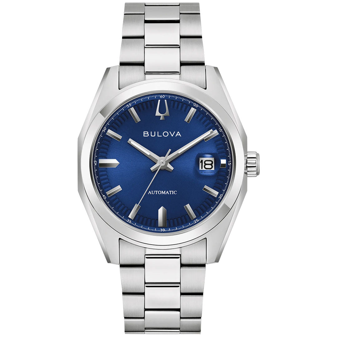 The Bulova Surveyor Automatic 39mm men’s watch features a blue dial with silver markers and hands, a date window at 3 o’clock, “Automatic” above 6, and a stainless steel bracelet for timeless style.