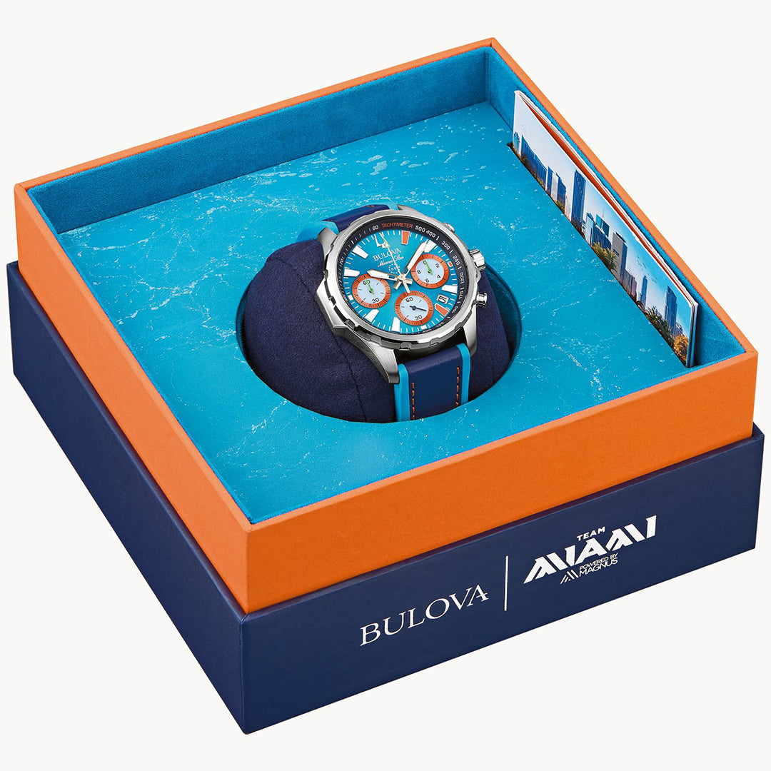 The Bulova E1 Team Miami Quartz 43mm Watch, a special edition, comes in an eye-catching display box with an orange and blue design. It showcases a blue face with orange and white accents, celebrating Team Miami E1 racing. The box features Bulova and Avani branding alongside two world landmark photos.