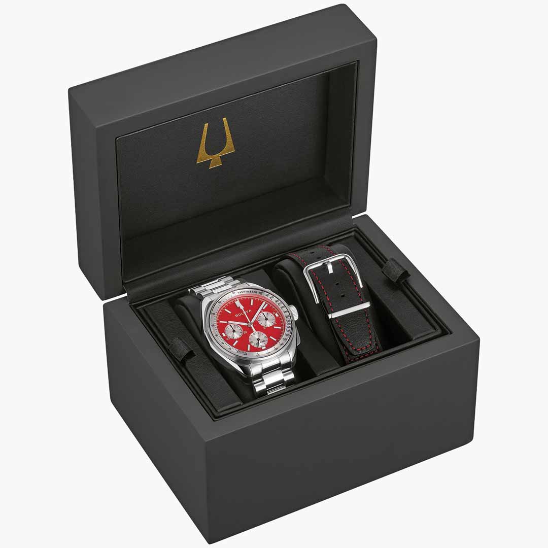 Presented in an open black box, the Bulova Lunar Pilot Quartz 43.5mm Watch from the Bulova Archive Series boasts a silver design with a striking red face and three subdials. This chronograph incorporates precision quartz movement and includes an extra black leather strap detailed with red stitching. The interior lining features a gold logo.