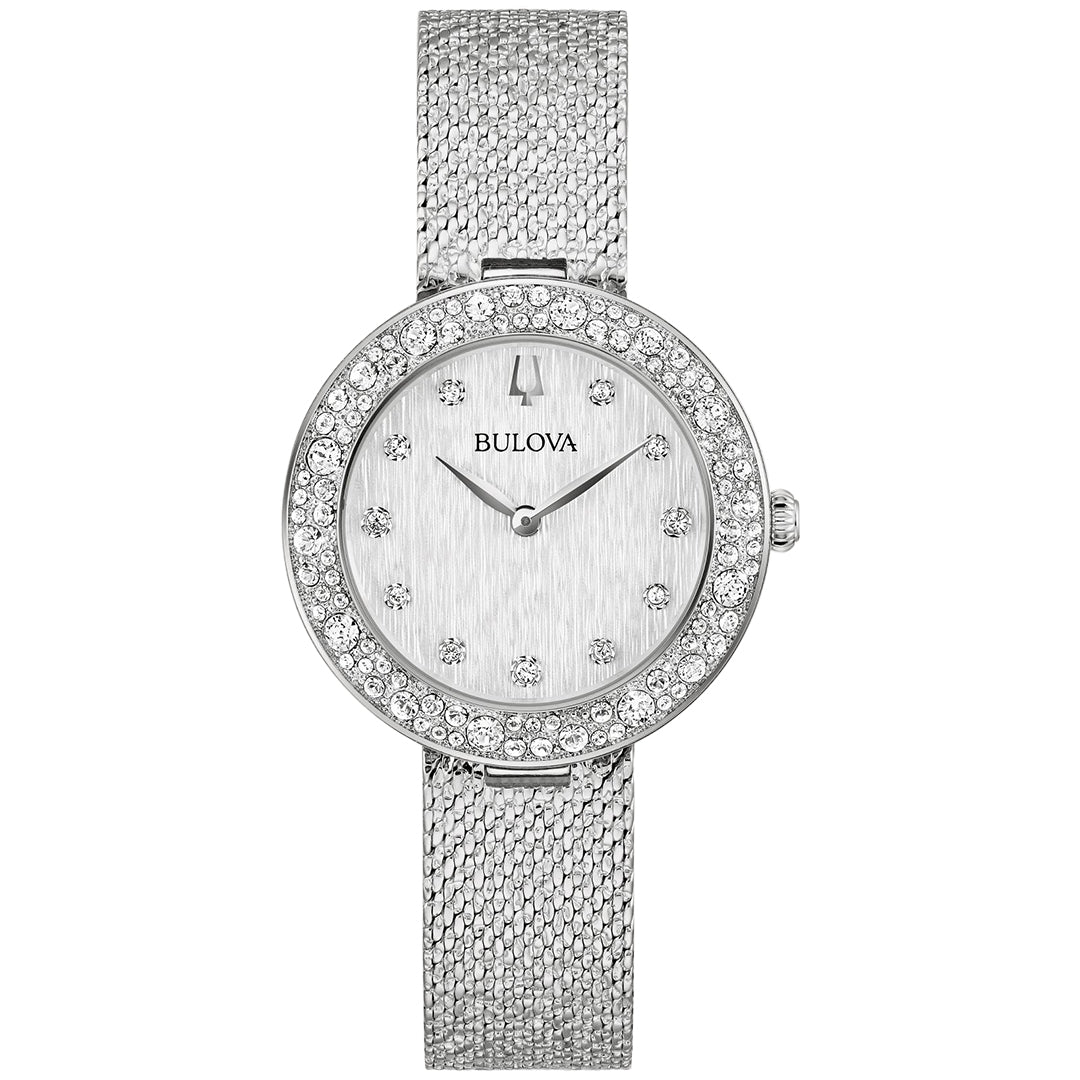 The Bulova Crystal Quartz 32mm Watch by Bulova is a stunning silver women's watch featuring a round face, diamond-studded bezel, and a silver-tone stainless steel mesh band. Its brushed dial has minimalist dot hour markers and two hands, radiating elegance and sophistication.