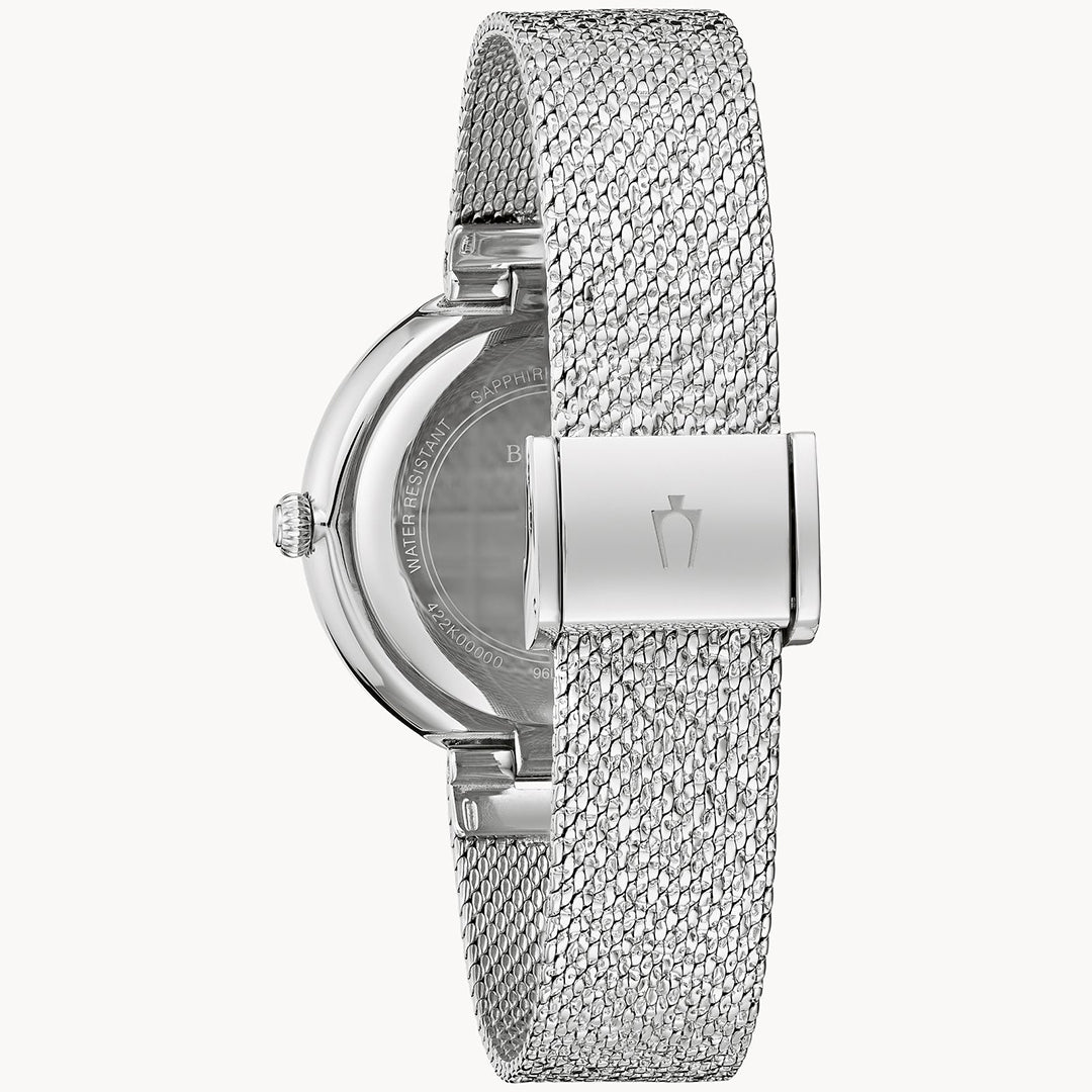 The Bulova Crystal Quartz 32mm Watch features a silver-tone stainless steel mesh strap and a round metal case, shown from the back with a clasp and textured band. Partially visible engraving adorns the back, while Austrian crystals enhance its timeless elegance.