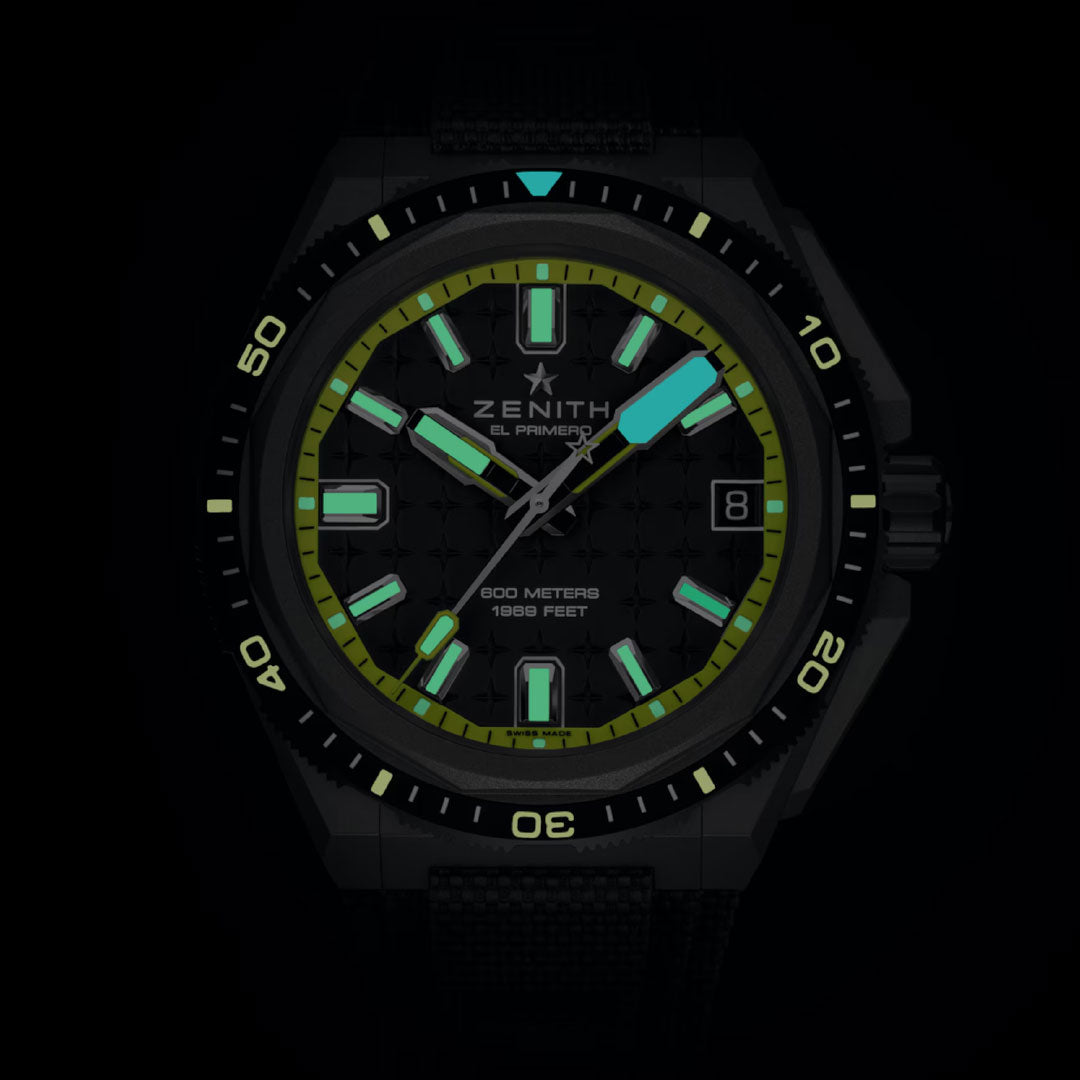 The Zenith Defy Extreme Diver El Primero 3620 43mm Watch features a black dial with glowing green and blue markers and hands, "ZENITH EL PRIMERO" at the top, helium escape valve, 800 meters/1000 feet rating, and a date window at 3 o’clock.