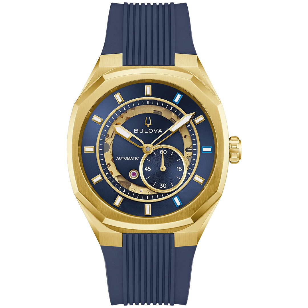Introducing the Bulova Surveyor Marc Anthony Automatic 40.5mm Watch by Bulova, designed for men with a gold-tone stainless steel case, striking blue dial adorned with gold hour markers and blue accents, and a coordinating blue rubber strap. This sophisticated timepiece features automatic movement and includes a small seconds subdial for enhanced functionality.