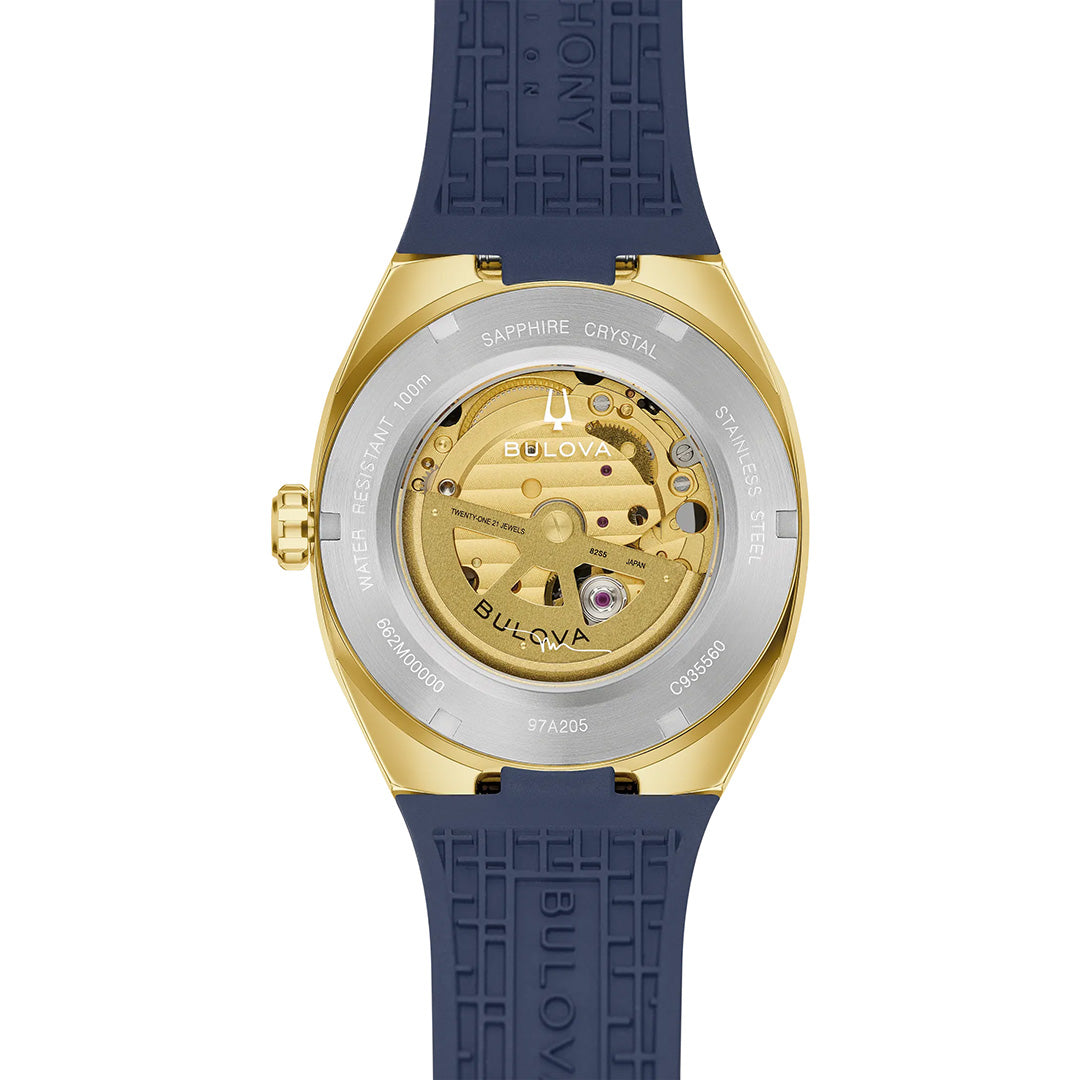 Close-up of the back of the Bulova Surveyor Marc Anthony Automatic 40.5mm men’s watch, featuring a blue strap and showcasing the intricate automatic movement and engraved details on the gold-tone stainless steel case back.